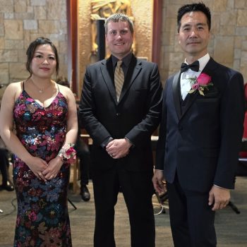 Wedding couple standing with a 1021 Events officiant after the ceremony