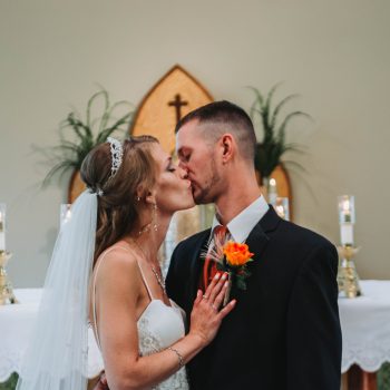 Bride and groom kissing after their church wedding ceremony