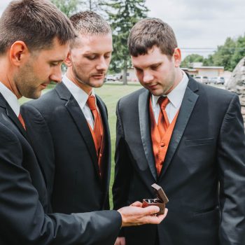 Groomsmen examining a wedding ring before the ceremony