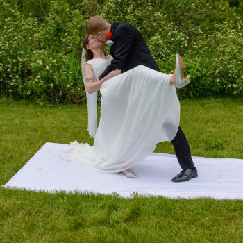 Bride and groom sharing a playful dip outdoors